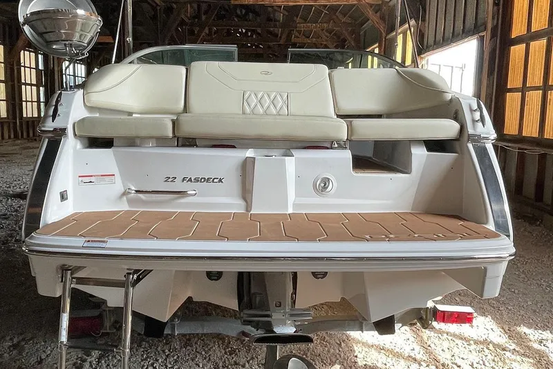 Slide: The Image of 2019 Regal 22 FasDeck boat rear view in a wooden boathouse. - 53