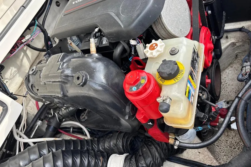 Slide: The Image of Engine compartment of a 2019 Regal 22 FasDeck boat, featuring Volvo components. - 56