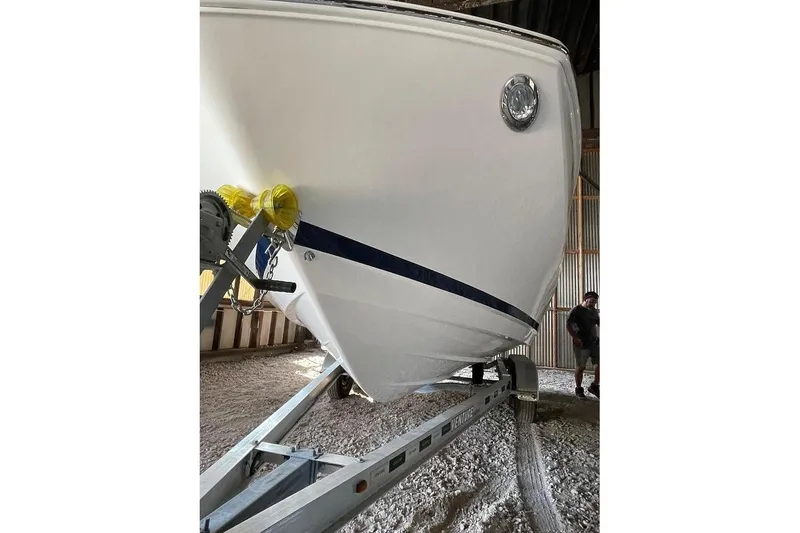Slide: The Image of 2019 Regal 22 FasDeck boat on trailer, side view with logo visible. - 9