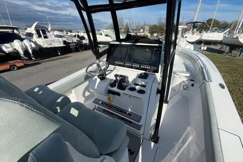 Slide: The Image of 2019 Sportsman Open 282 Center Console boat with dual seats and steering wheel. - 13