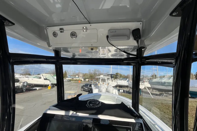 Slide: The Image of 2019 Sportsman Open 282 Center Console boat in marina under sunny sky. - 15