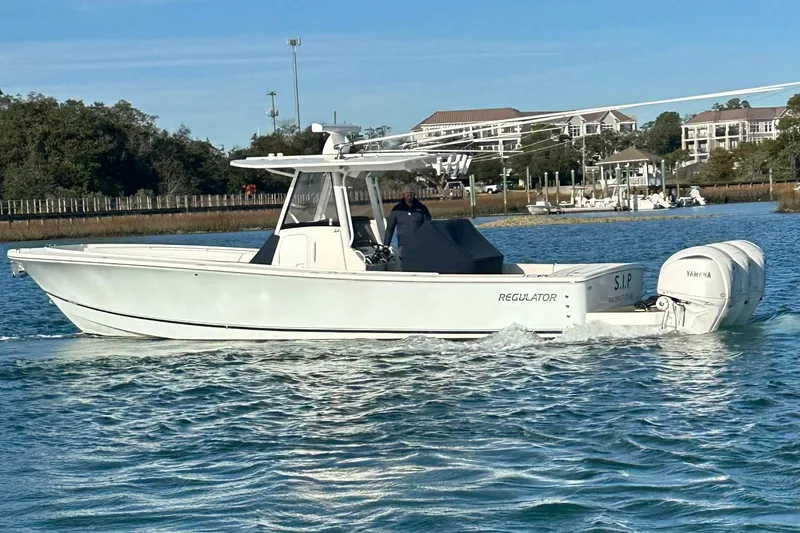 The Image of 2024 Regulator 34 Center Console boat cruising on a calm waterway. - 0