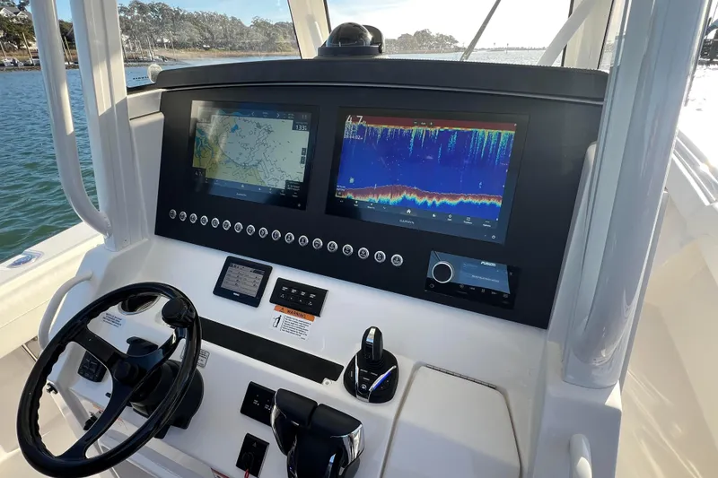 Slide: The Image of 2024 Regulator 34 Center Console boat on trailer, parked outdoors. - 5