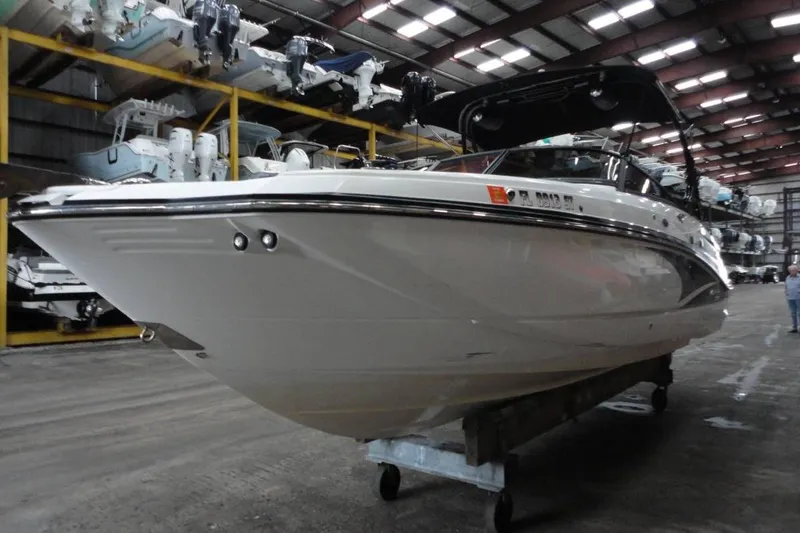 Slide: The Image of 2021 Monterey M-65 boat in storage facility, showcasing sleek design and powerful engine. - 3