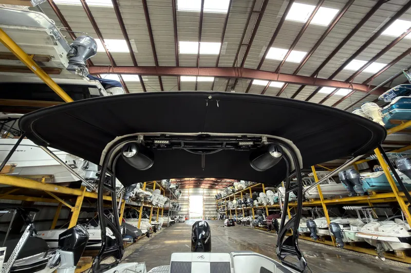 Slide: The Image of 2021 Monterey M-65 boat in storage, featuring a black canopy and modern design. - 32