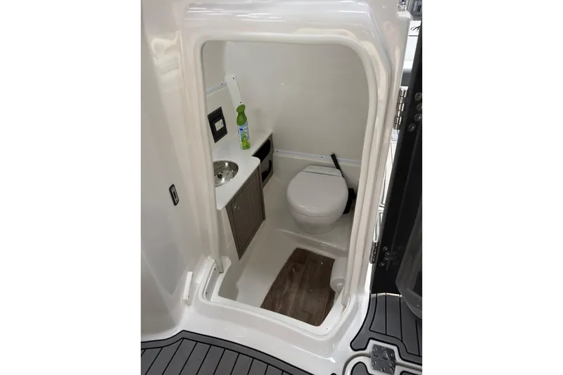 Slide: The Image of Compact bathroom in 2021 Monterey M-65 boat with toilet, sink, and storage. - 33
