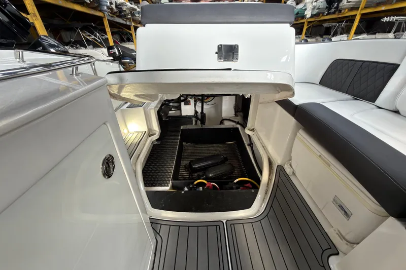 Slide: The Image of Interior view of a 2021 Monterey M-65 boat, showcasing seating and storage compartments. - 34