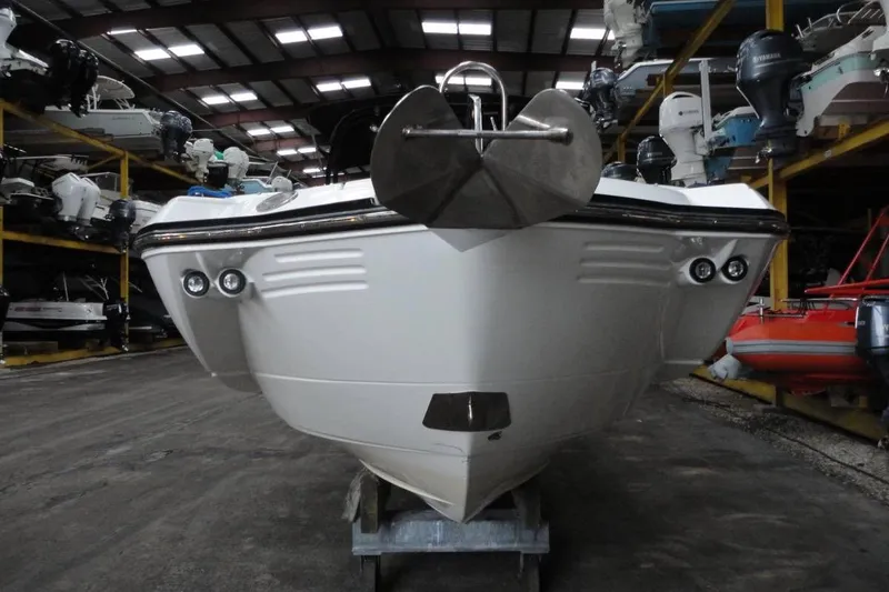 Slide: The Image of 2021 Monterey M-65 boat in indoor storage facility with multiple boats. - 4