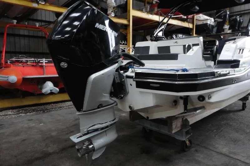 Slide: The Image of 2021 Monterey M-65 boat stored in a spacious indoor facility with multiple vessels. - 7