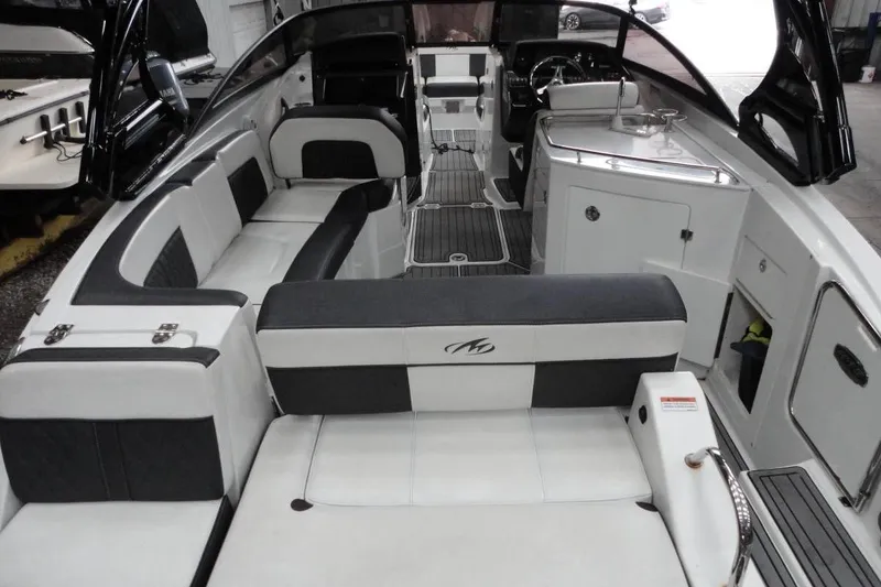 Slide: The Image of 2021 Monterey M-65 boat in storage, rear view with visible propeller and engine. - 9