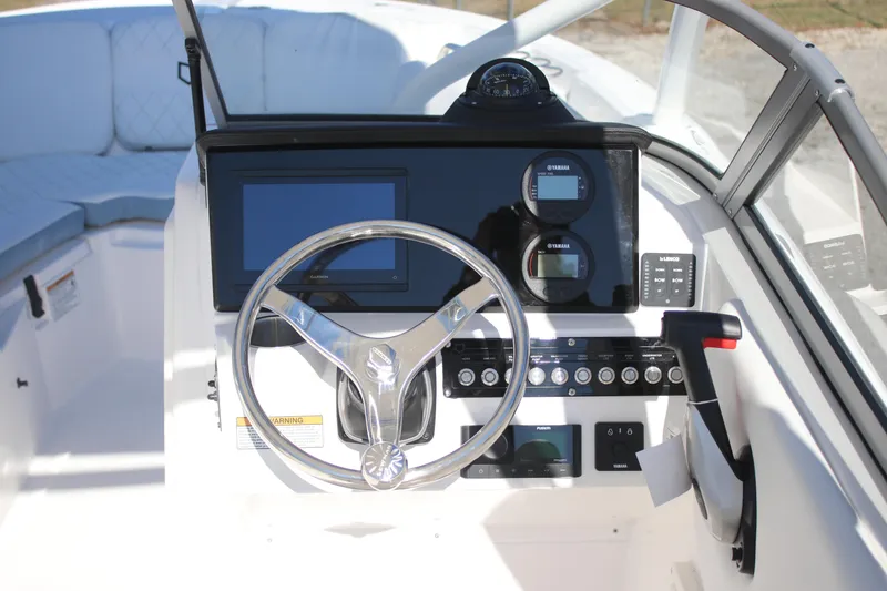 Slide: The Image of 2026 Sea Fox 228 Traveler boat dashboard with steering wheel and modern controls. - 8
