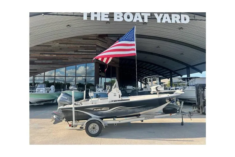 Slide: The Image of 2010 Blue Wave 180 V BAY boat with American flag at The Boat Yard. - 11