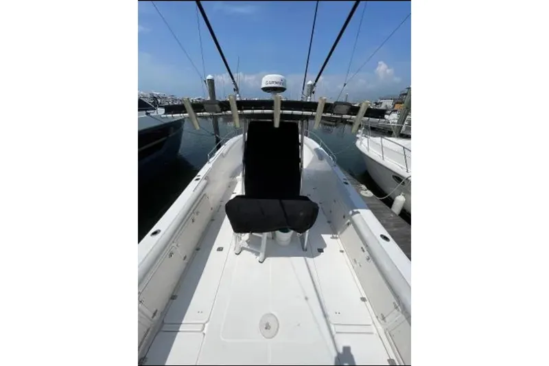 Slide: The Image of 2004 Century 3200 Center Console boat docked at marina, clear sky background. - 11