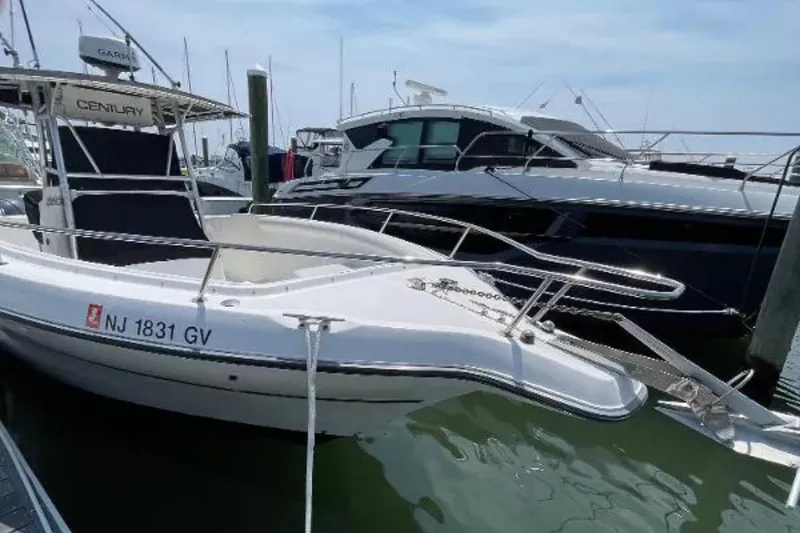 Slide: The Image of 2004 Century 3200 Center Console boat docked at marina. - 13