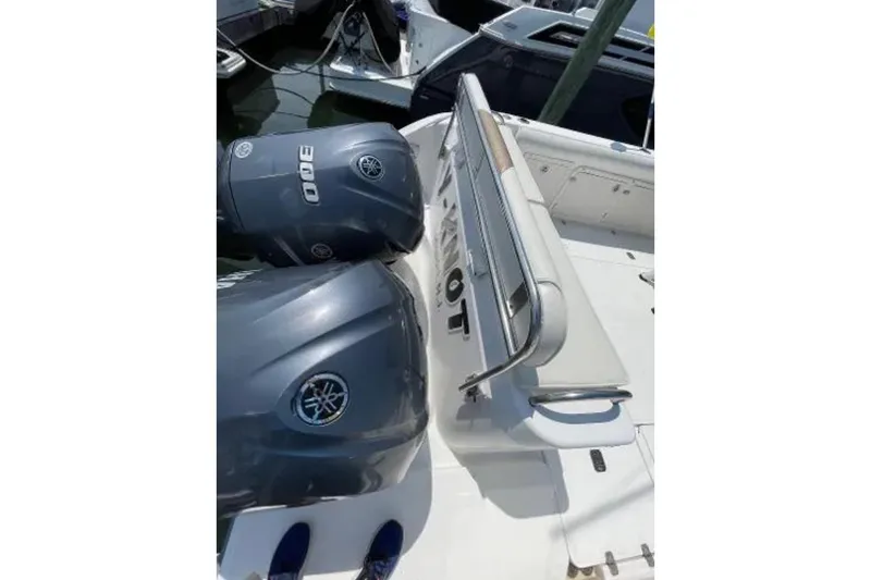 Slide: The Image of 2004 Century 3200 Center Console boat with dual Yamaha 300 engines at dock. - 21
