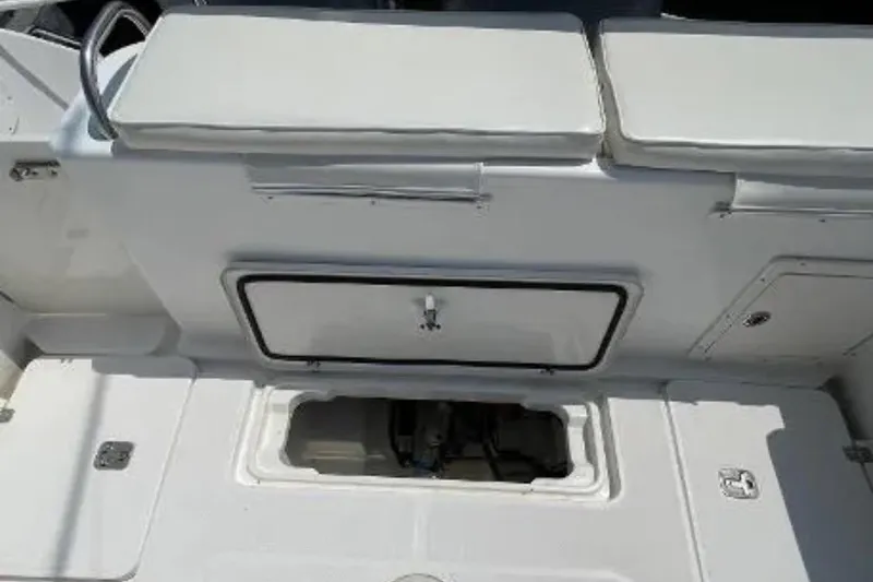 Slide: The Image of 2004 Century 3200 Center Console boat interior with storage compartments and seating. - 23