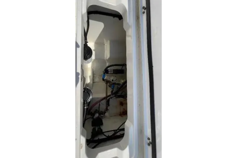 Slide: The Image of 2004 Century 3200 Center Console boat interior compartment with visible wiring and components. - 24