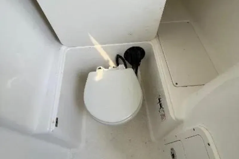 Slide: The Image of 2004 Century 3200 Center Console boat toilet interior view. - 30