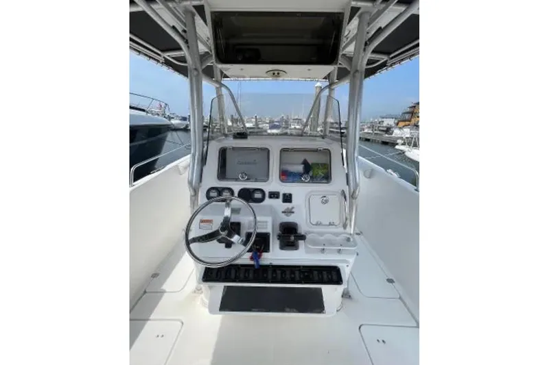 Slide: The Image of 2004 Century 3200 Center Console boat interior with steering wheel and control panel. - 32
