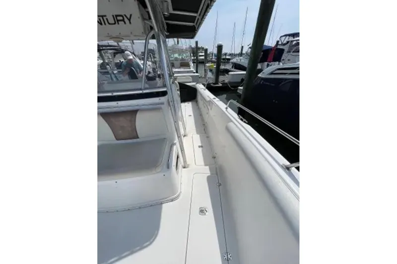 Slide: The Image of 2004 Century 3200 Center Console boat docked at marina, side view. - 33