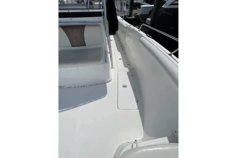 Slide: The Image of 2004 Century 3200 Center Console boat deck, featuring sleek white design and spacious layout. - 35