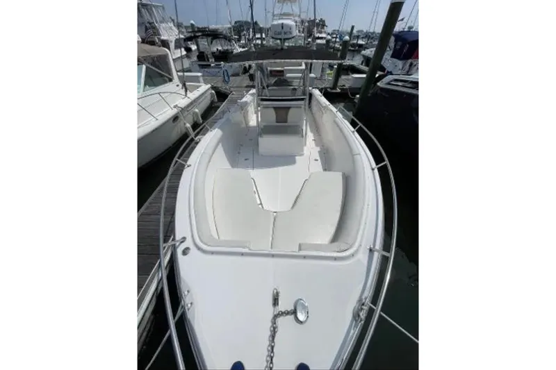 Slide: The Image of 2004 Century 3200 Center Console boat docked at a marina, showcasing spacious deck layout. - 36