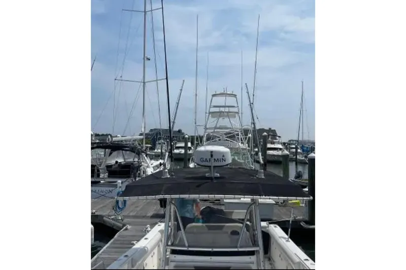 Slide: The Image of 2004 Century 3200 Center Console boat docked at a marina with clear skies. - 37