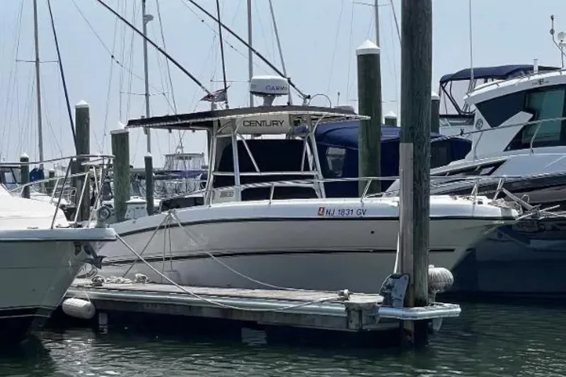 Slide: The Image of 2004 Century 3200 Center Console boat docked at a marina. - 4