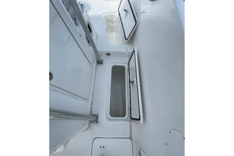 Slide: The Image of 2004 Century 3200 Center Console boat interior with open storage compartments. - 44