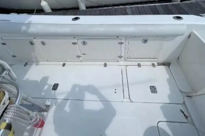 Slide: The Image of 2004 Century 3200 Center Console boat deck with storage compartments and seating. - 45
