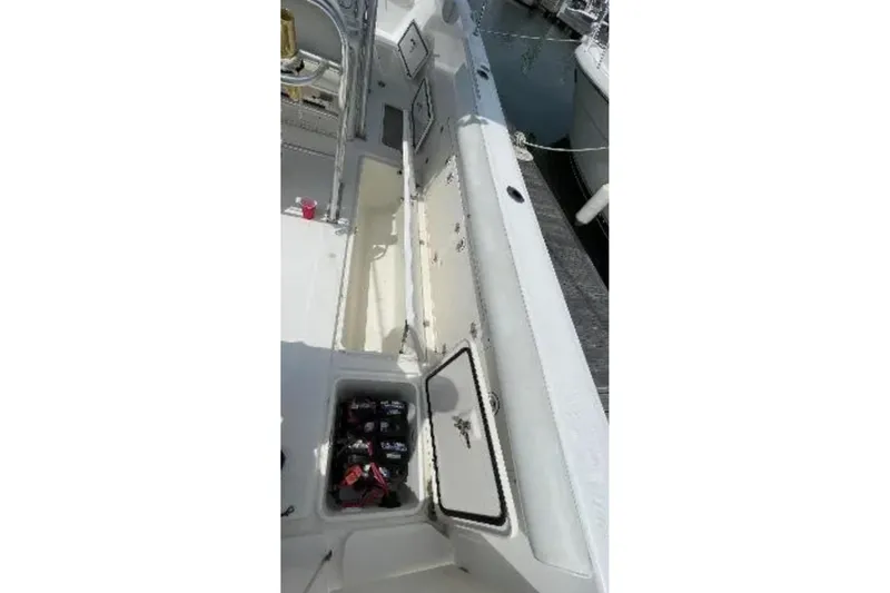 Slide: The Image of 2004 Century 3200 Center Console boat interior with storage compartments open. - 47