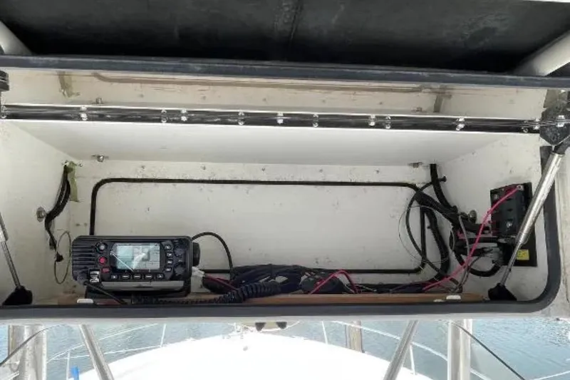 Slide: The Image of 2004 Century 3200 Center Console boat electronics compartment with radio and wiring. - 54