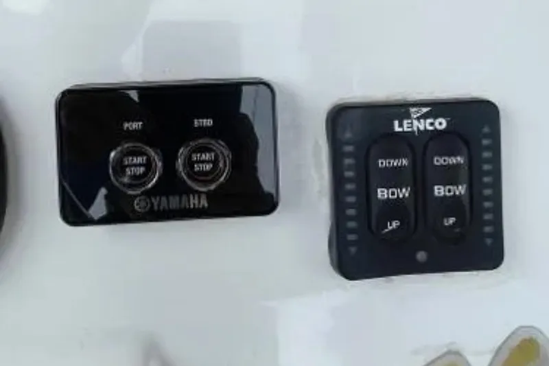 Slide: The Image of Control panel of a 2004 Century 3200 Center Console boat with Yamaha and Lenco switches. - 55