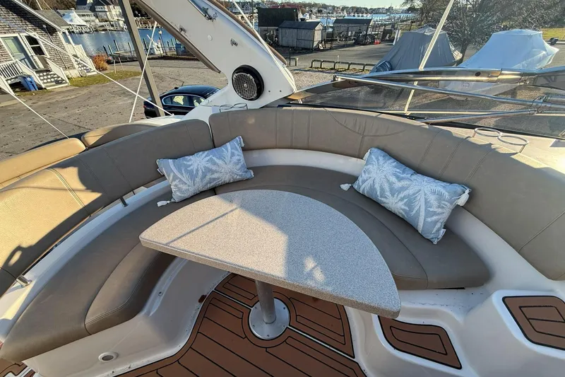 Slide: The Image of 2002 Regal Commodore 3860 boat interior with curved seating and decorative cushions. - 18