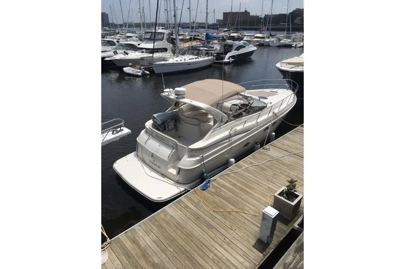 Slide: The Image of 2002 Regal Commodore 3860 yacht docked at marina, surrounded by other boats. - 20
