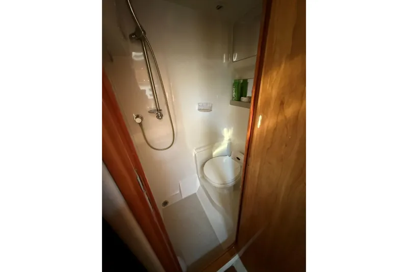 Slide: The Image of 2002 Regal Commodore 3860 bathroom with shower and toilet, compact and functional design. - 9