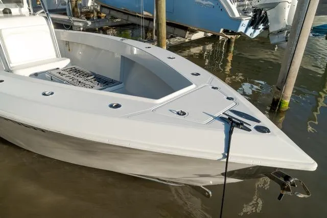 Slide: The Image of 2015 Bahama 34 boat docked, showcasing sleek design and spacious deck. - 12