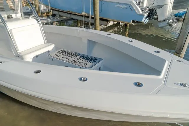 Slide: The Image of 2015 Bahama 34 boat docked, featuring spacious seating and sleek design. - 13