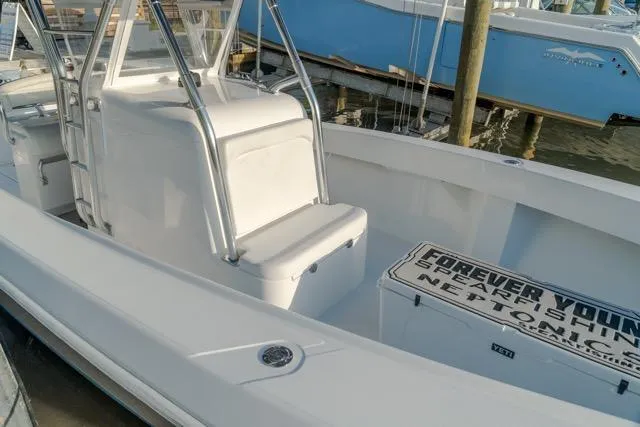 Slide: The Image of 2015 Bahama 34 boat with seating and storage, docked at a marina. - 14