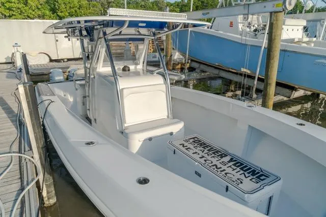 Slide: The Image of 2015 Bahama 34 boat docked, featuring a sleek design and spacious deck. - 15