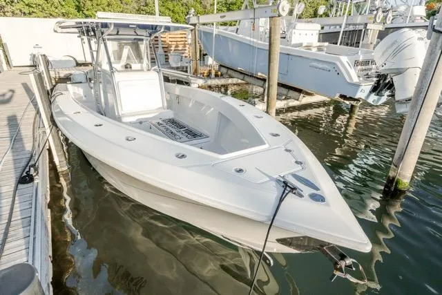 Slide: The Image of 2015 Bahama 34 boat docked in marina, featuring sleek design and spacious deck. - 18