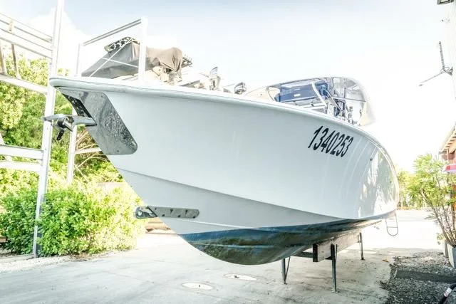 Slide: The Image of 2015 Bahama 34 boat on dry dock, white hull, registration number visible. - 29