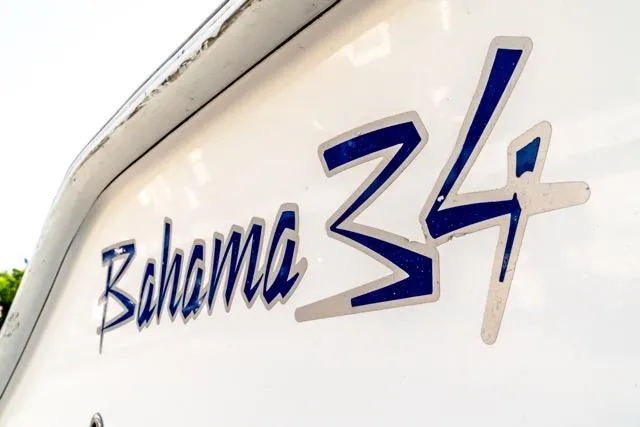 Slide: The Image of Close-up of 2015 Bahama 34 boat logo on white surface. - 38