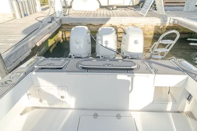 Slide: The Image of 2015 Bahama 34 boat with triple Suzuki outboard engines at dock. - 39