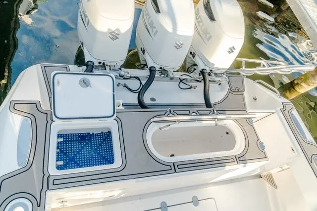 Slide: The Image of 2015 Bahama 34 boat with triple Suzuki outboard engines, featuring a sleek deck design. - 42