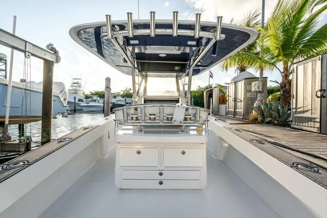 Slide: The Image of 2015 Bahama 34 boat docked, featuring a sleek design and spacious deck area. - 43