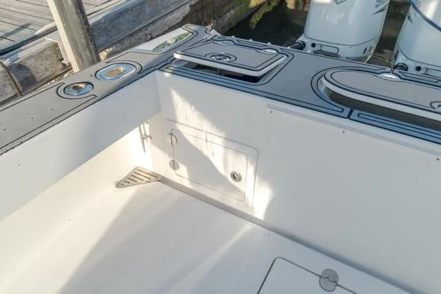 Slide: The Image of 2015 Bahama 34 boat deck with storage compartments and fishing rod holders. - 44