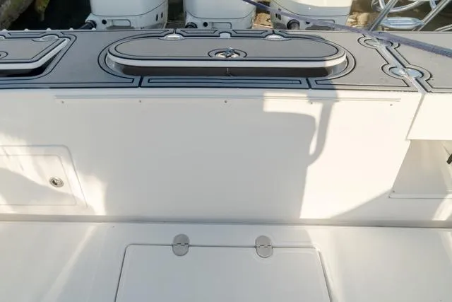 Slide: The Image of 2015 Bahama 34 boat deck with storage compartments and sleek design. - 45