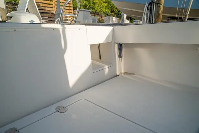 Slide: The Image of 2015 Bahama 34 boat interior with clean, spacious deck and storage compartments. - 50