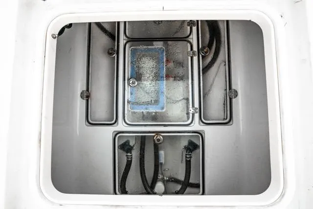 Slide: The Image of 2015 Bahama 34 boat compartment with visible wiring and components. - 52